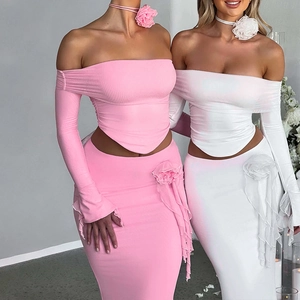 Detail of elegant two-piece set featuring off-shoulder top and skirt with rose choker