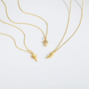 Gold Radiant Star and mushroom pendant necklaces on a minimalist white background