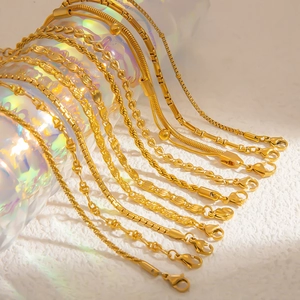 Macro view of various 18k gold plated stainless steel chain styles on a glass cylinder