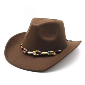Detail of a brown wool felt cowboy hat featuring a colorful tribal beaded ethnic band