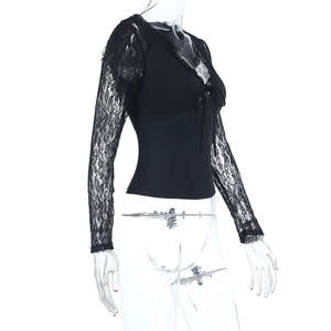 Detail view of the elegant black lace V-neck top with lace splicing and a delicate bow tie