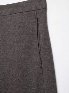 Detailed view of dark brown wool blend twill fabric and high waist stitching on trousers