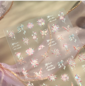 Detailed laser nail stickers with butterfly and flower patterns on purple mesh backdrop