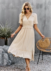 Chic beige V-neck maxi dress with a cinched waist and elegant ruffle hem for a vacation look