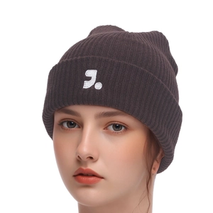 Detail of dark brown ribbed knit beanie featuring a white embroidered J letter logo