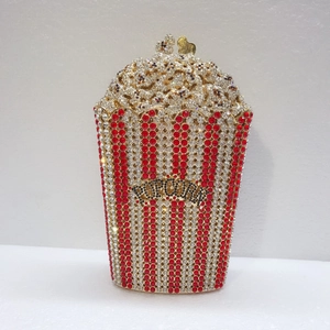Detailed close-up of crystal popcorn evening bag with red and silver rhinestone stripes