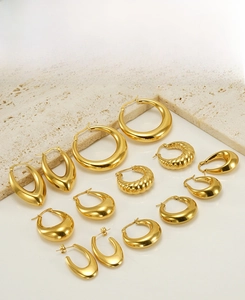 Detail view of gold-plated hollow earrings in various geometric and textured styles