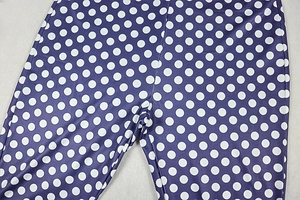 Detailed close-up of purple polka dot yoga pants featuring durable stitching and elastic fabric