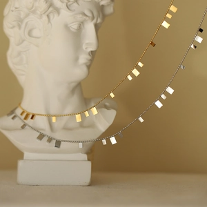 Artistic display of gold and silver sequin necklaces on David plaster sculpture