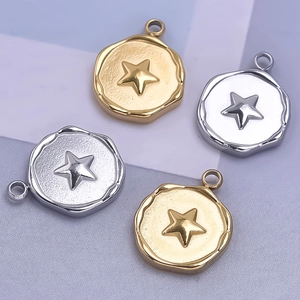 Detail of round star charms with embossed pentagram in gold and silver finish for jewelry