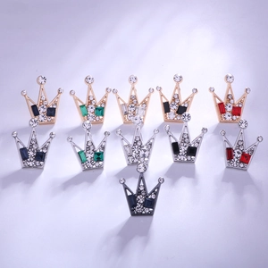 Detail of assorted crown lapel pins with colorful crystals and polished metal base