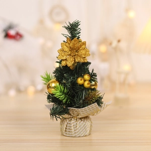 Mini Christmas tree desktop ornament with gold decorations and fabric base in warm room