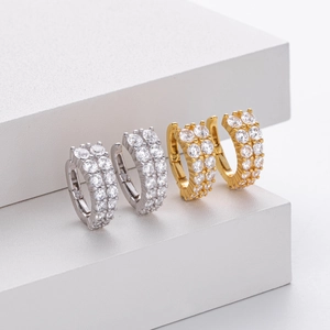 Detailed macro view of S925 silver hoop earrings with double-row micro-paved cubic zirconia