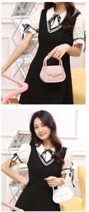 Detail of trendy mini PVC jelly handbags in pink and off-white with round buckle closure