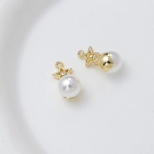 Detailed macro view of golden star-shaped alloy pendants with white pearls and zircons