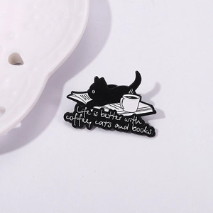 Cute black cat enamel brooch with coffee and books featuring a life is better text design