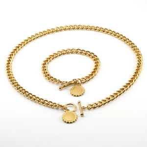 Parure de bijoux dorés avec fermoir OT, maille gourmette et pendentifs tournesol