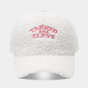 White teddy fleece baseball cap featuring pink Tanned and Tipsy letter embroidery design
