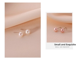 Detail view of small white and pink pearl stud earrings on elegant silk background
