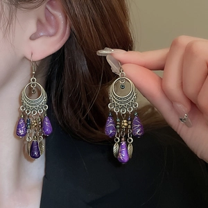 Bohemian drop earrings featuring vintage bronze leaf charms and long navy blue tassels