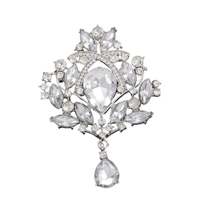 Detail of vintage silver crystal brooch with teardrop rhinestone pendant on white background