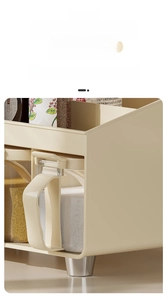 Detail view of cream storage rack with elevated metal legs for kitchen organization