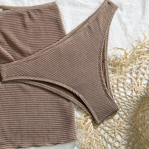 Detail showing the waffle textured fabric of this pink two-piece bikini beachwear set