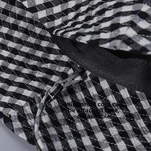 Detail view of the detachable windproof rope attachment on plaid bucket hat inner rim