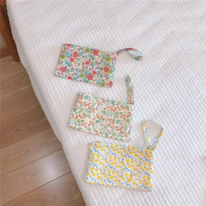 Three-piece cotton floral mini phone bags with wrist straps and zipper closure