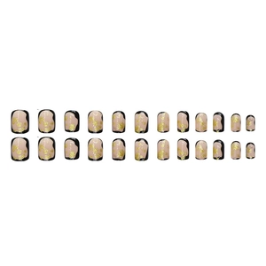 Luxurious short nude press-on nails with black abstract edges and golden foil accents
