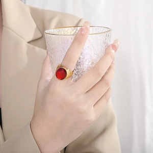 Vintage gold-plated titanium steel ring featuring a large faceted oval red gemstone