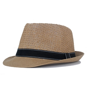 Detail of light brown straw fedora with fine weave and black decorative ribbon trim