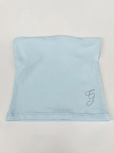 Light blue ribbed knit headband with silver sequin G logo, soft texture flat lay