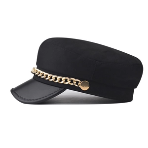 Classic black baker boy hat with leather visor and decorative gold chain accent