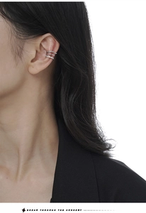 Macro shot of minimalist silver layered ear cuff with micro-pave twisted lines on model