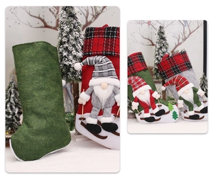 Detail of plush Christmas stockings with 3D gnomes, ski accents and red plaid patterns