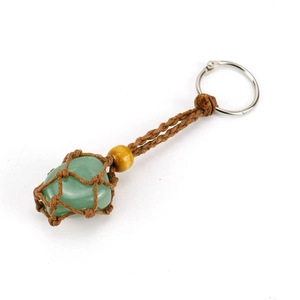 Detail of green natural stone keychain with brown woven net bag and wooden bead decoration