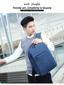 Close-up of waterproof textured fabric and hidden front zipper on this navy business backpack