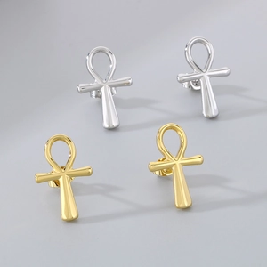 Detailed view of silver and gold Ankh cross stud earrings in polished stainless steel