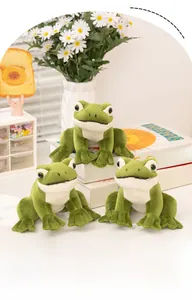 Three green sitting frog plush toys with big eyes and soft texture in a home setting