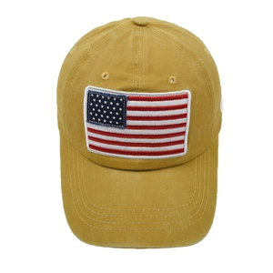 Detailed close-up of mustard yellow baseball cap with American flag embroidered patch