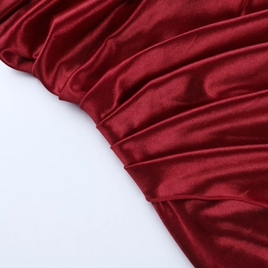 Close-up of premium red satin fabric showing elegant drapes and glossy texture