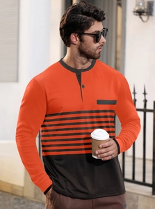 Detail of orange and black striped Henley shirt featuring buttoned neckline on male model