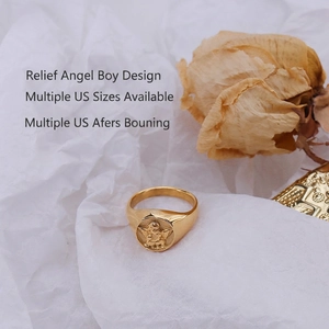 Vintage style gold angel relief signet ring with Cupid motif on a white background