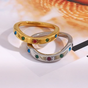 Macro detail of 18K gold and silver plated rings with colorful starburst gemstones
