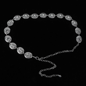 Detail of silver metal waist chain with engraved oval links and adjustable lobster clasp