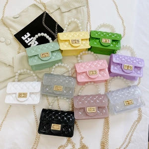 Detailed flat lay of small quilted jelly bags with pearl handles in 11 vibrant colors