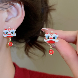 Close-up detail of Chinese lion dance earring with red tassel and white plush trim