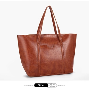 Detail of vintage oil wax leather tote bag side view with external pocket and stitching