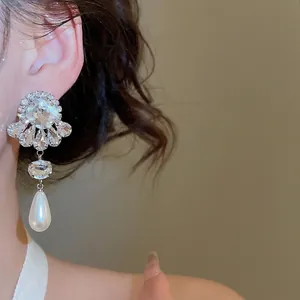 Elegant silver earrings with sparkling flower crystals and long teardrop pearls for women